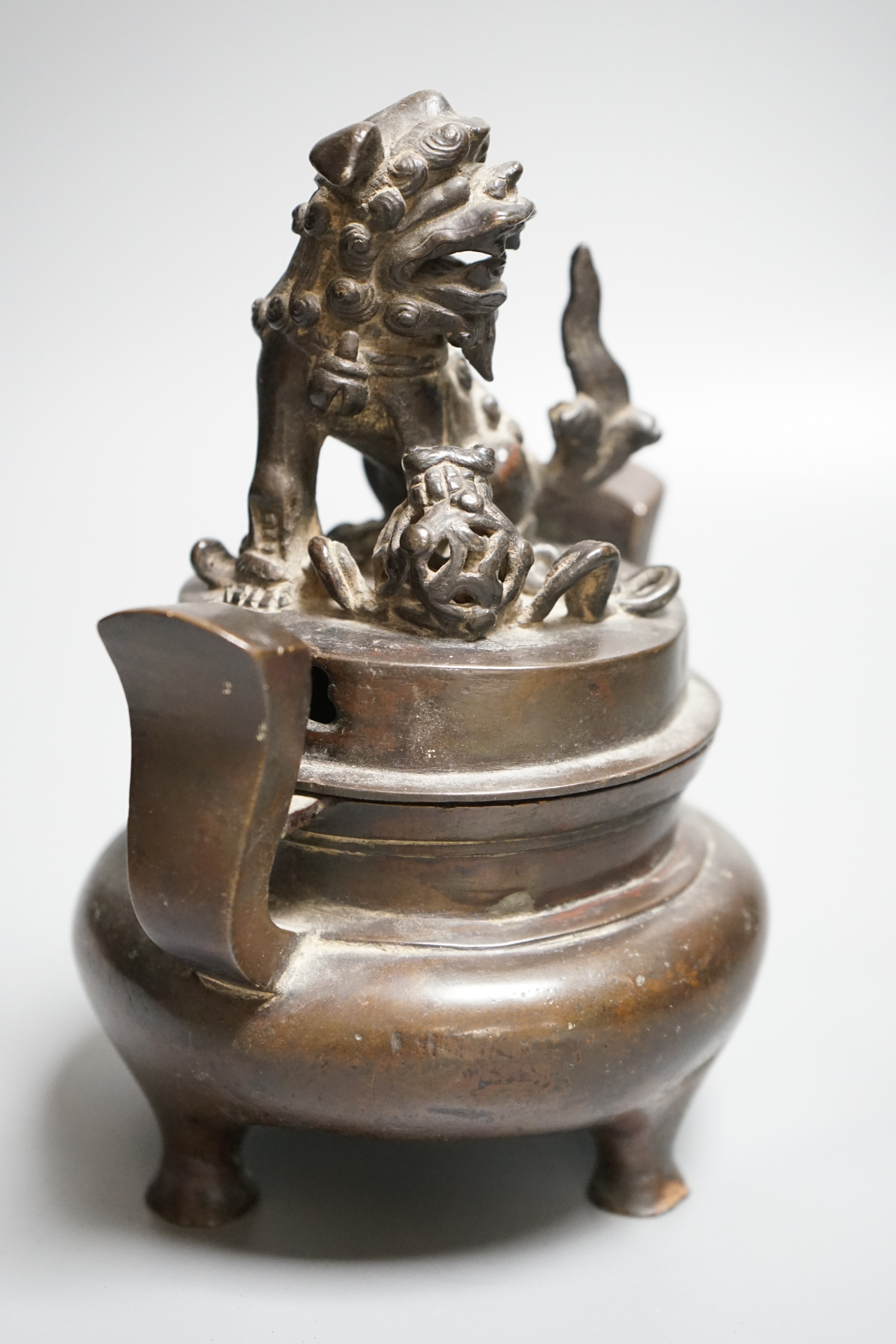 A Chinese copper alloy censer and cover with lion dog cover, height 20cm